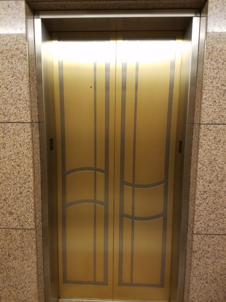 Satin finish bronze and stainless steel side by side, accenting the beautiful pattern in these elevator doors